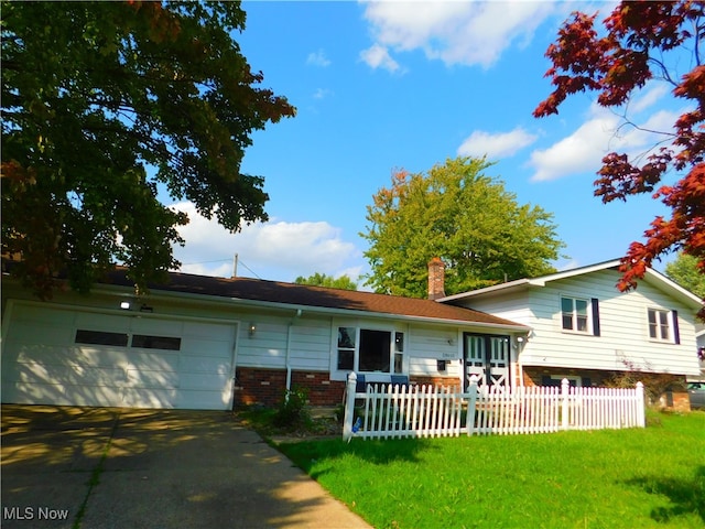 view of front facade with a front yard and a garage