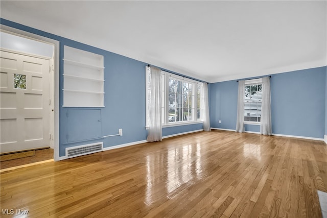 unfurnished living room featuring light wood-type flooring