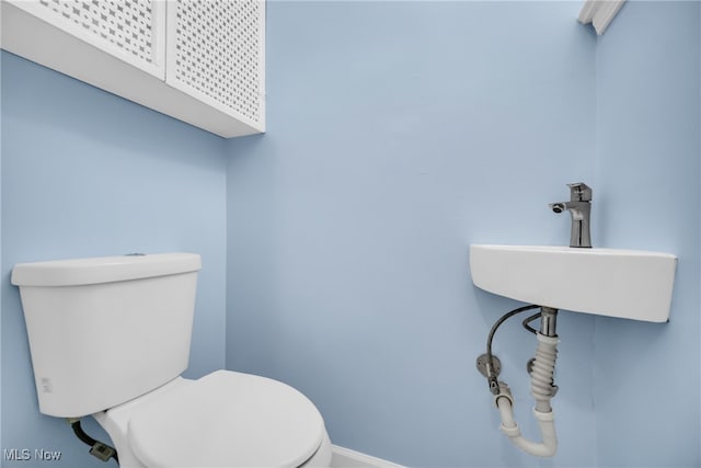 bathroom featuring sink and toilet