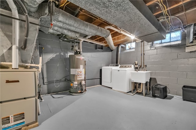 basement featuring separate washer and dryer, sink, and gas water heater