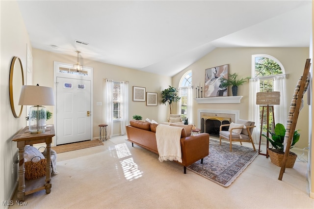 living room with light carpet and vaulted ceiling