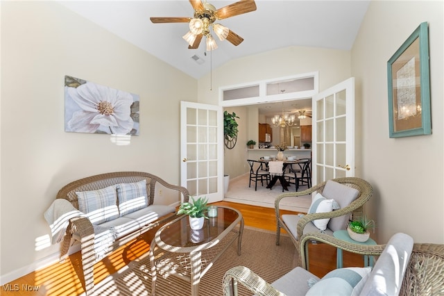 interior space with lofted ceiling, hardwood / wood-style floors, french doors, and ceiling fan