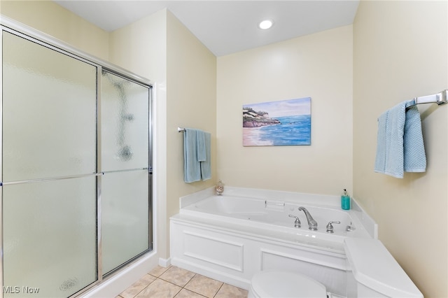 bathroom with toilet, tile patterned floors, and plus walk in shower