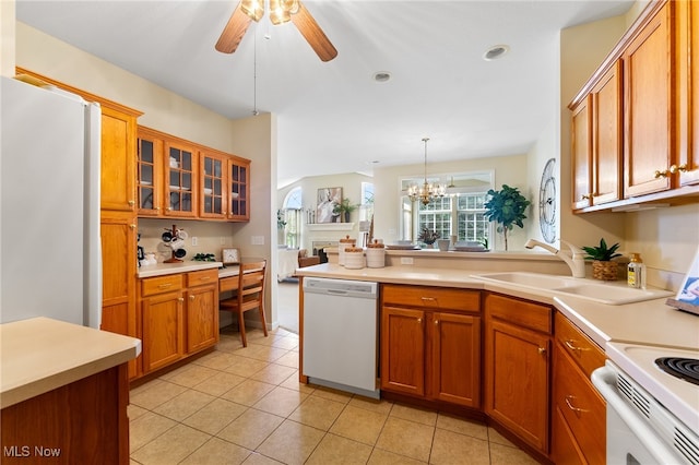 kitchen featuring white appliances, sink, ceiling fan with notable chandelier, pendant lighting, and light tile patterned floors