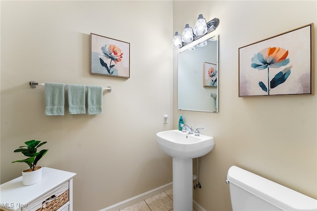 bathroom featuring toilet and tile patterned flooring