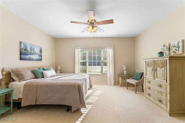 bedroom featuring ceiling fan and light carpet