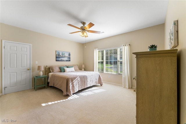 bedroom with light colored carpet and ceiling fan