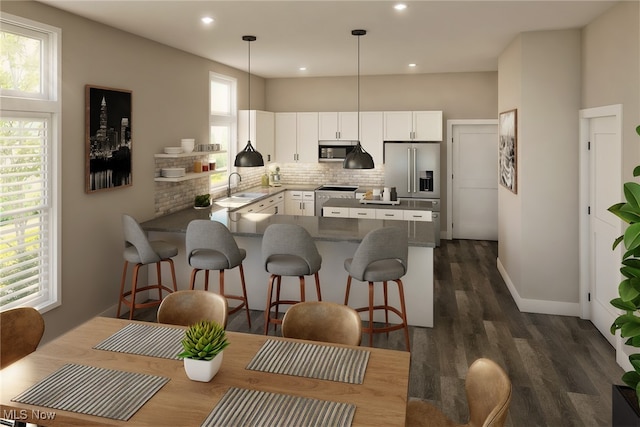 kitchen with tasteful backsplash, stainless steel appliances, sink, pendant lighting, and white cabinets