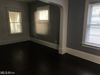 spare room with dark hardwood / wood-style flooring