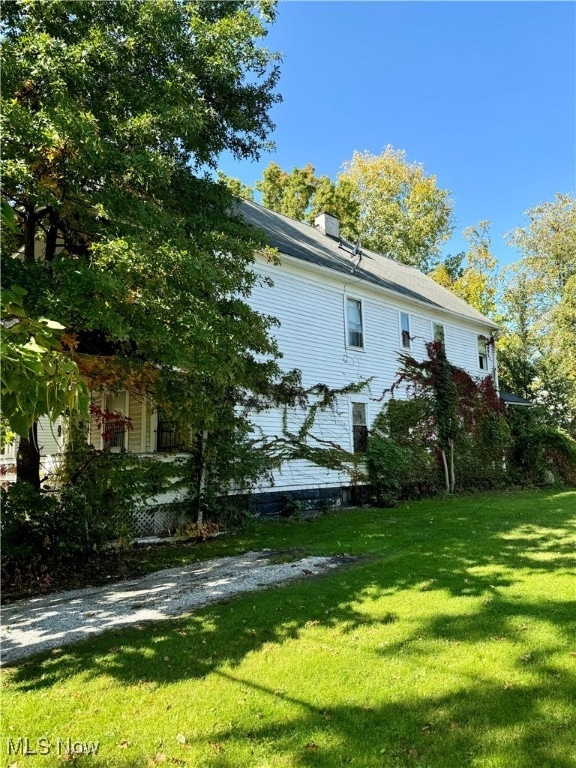 view of side of home featuring a yard