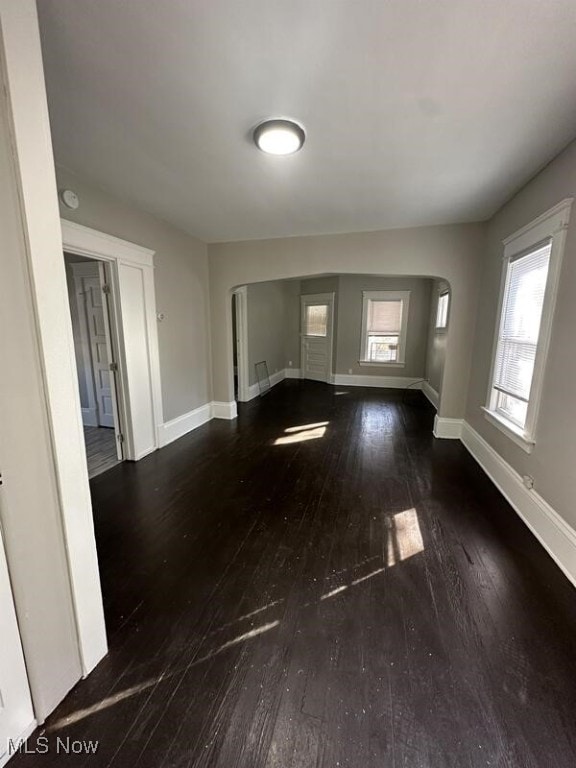 unfurnished living room featuring dark hardwood / wood-style flooring