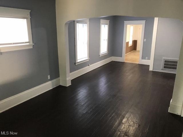 spare room featuring dark hardwood / wood-style floors