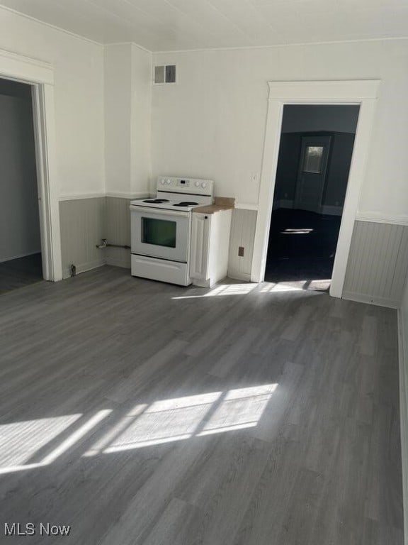 kitchen featuring dark wood-type flooring, white cabinetry, and white electric stove