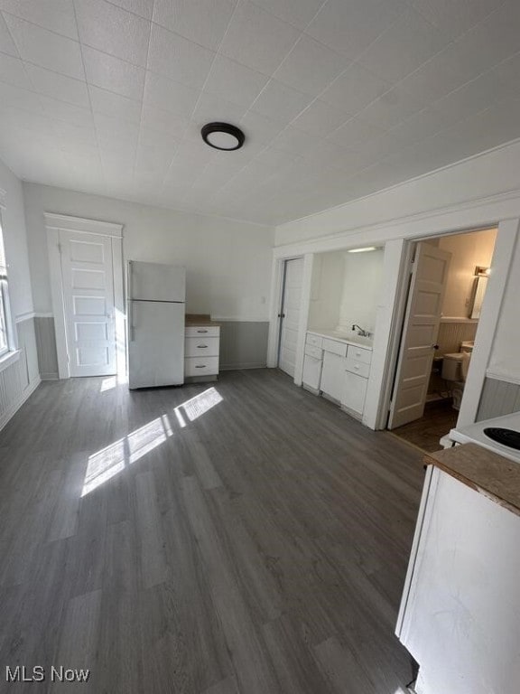 unfurnished living room featuring dark hardwood / wood-style floors