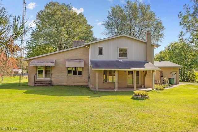 rear view of house featuring covered porch and a lawn