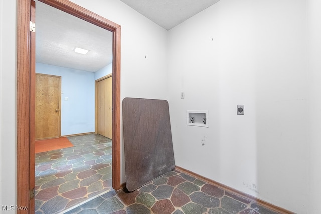 laundry room featuring a textured ceiling, washer hookup, and electric dryer hookup