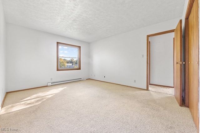 unfurnished room with light carpet, a textured ceiling, and baseboard heating