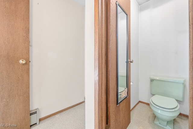 bathroom with baseboard heating and toilet