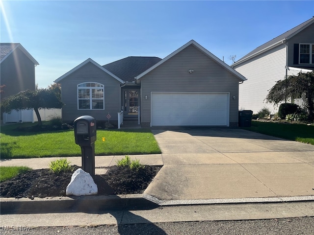 view of front of home with a front lawn and a garage