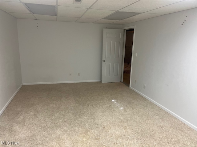 empty room with carpet and a drop ceiling