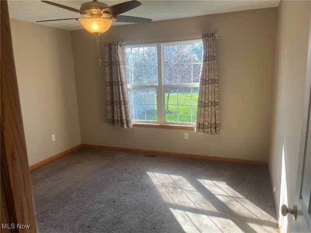 carpeted empty room with ceiling fan