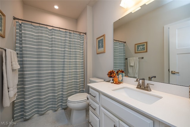 bathroom with vanity, toilet, and tile patterned floors