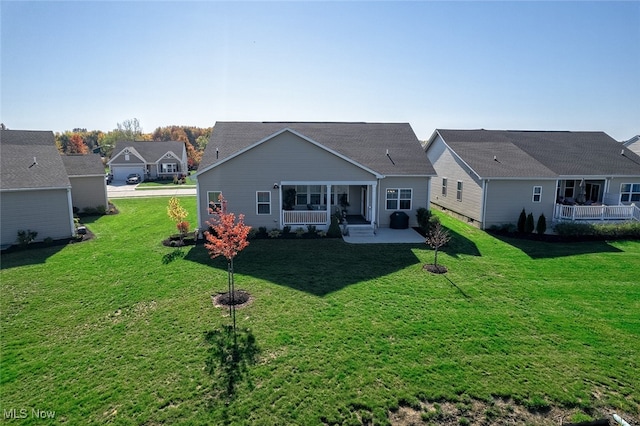 rear view of property with a lawn