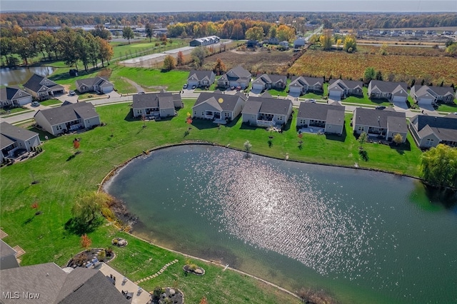 birds eye view of property with a water view