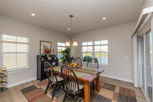 dining area featuring a chandelier and light wood-type flooring