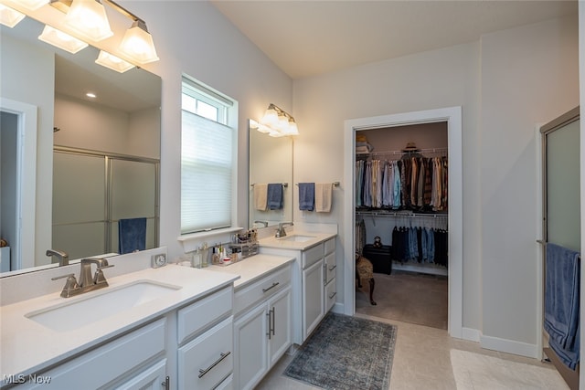 bathroom with vanity, an enclosed shower, and tile patterned flooring