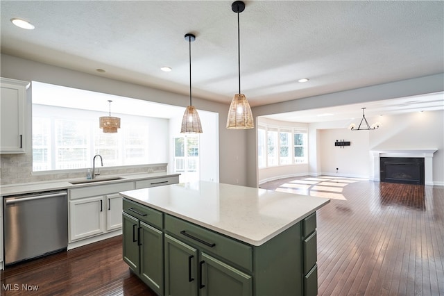 kitchen with dishwasher, a kitchen island, sink, white cabinets, and dark hardwood / wood-style flooring