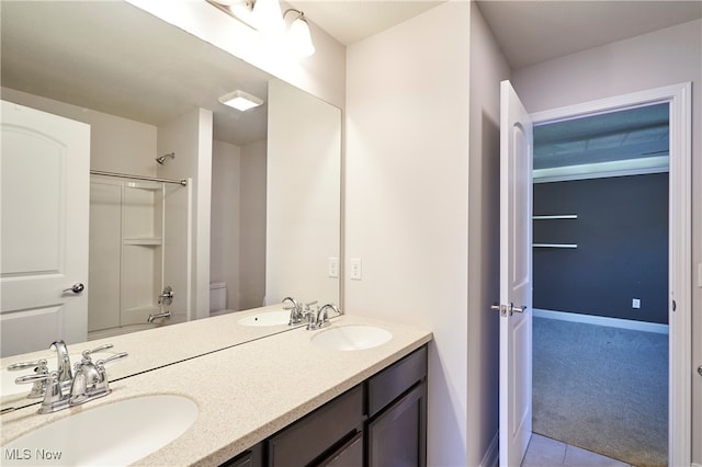 bathroom featuring vanity, toilet, and tile patterned flooring