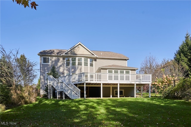 back of house with a deck and a lawn