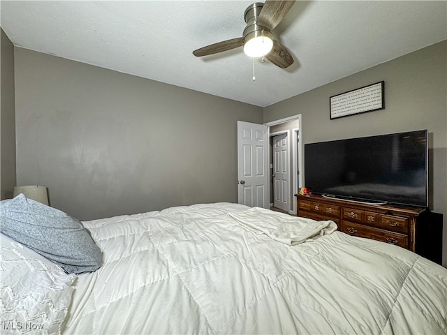 bedroom with a textured ceiling and ceiling fan