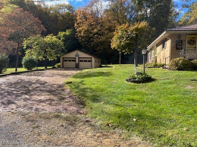 view of yard with an outbuilding and a garage