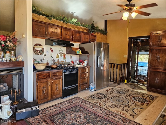 kitchen with ceiling fan, light tile patterned floors, black stove, a textured ceiling, and stainless steel refrigerator with ice dispenser