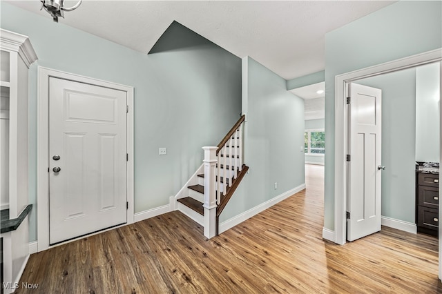 foyer entrance featuring a textured ceiling and light hardwood / wood-style flooring