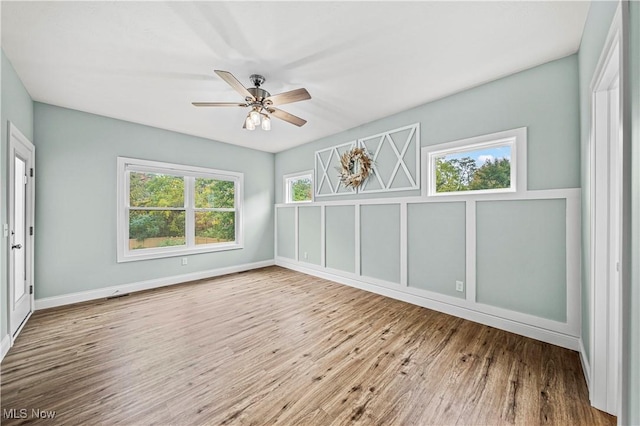 unfurnished room with hardwood / wood-style flooring and ceiling fan