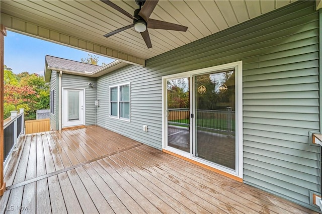 wooden deck featuring ceiling fan