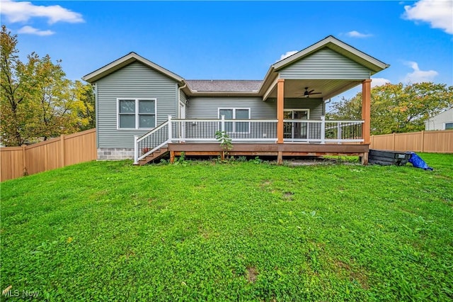 rear view of house with a lawn, ceiling fan, and a deck