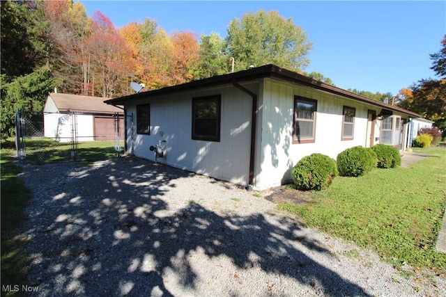 view of side of home featuring a lawn