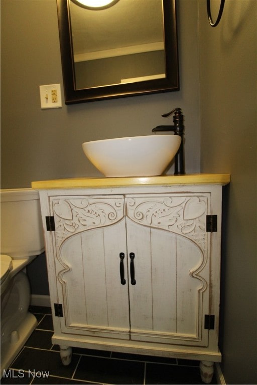 bathroom with tile patterned flooring, toilet, and sink