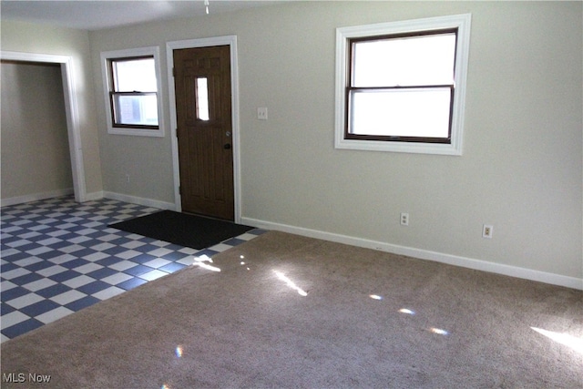 view of carpeted foyer entrance