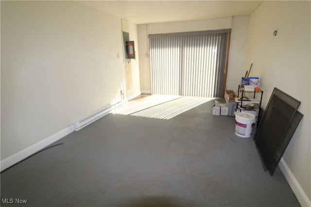 unfurnished living room with concrete floors and electric panel