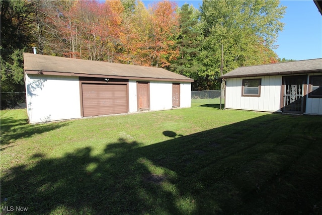 view of yard with an outbuilding and a garage