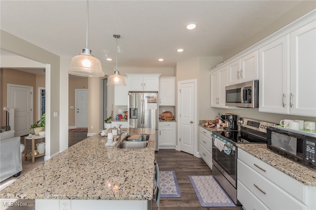 kitchen featuring stainless steel appliances, sink, and an island with sink