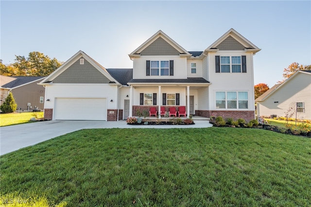 craftsman inspired home featuring a front lawn, covered porch, and a garage