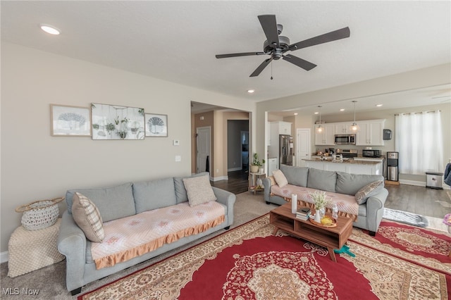 living room with dark hardwood / wood-style floors and ceiling fan