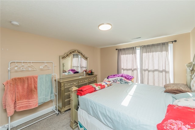 bedroom featuring light carpet