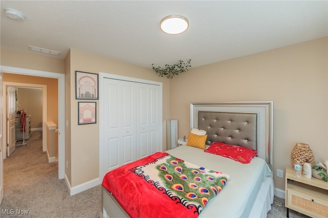 bedroom with a closet and light colored carpet